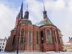 View of a red brick building with several steeples