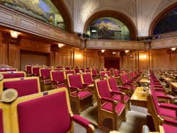 Red wooden chairs in Stockholm Parliament